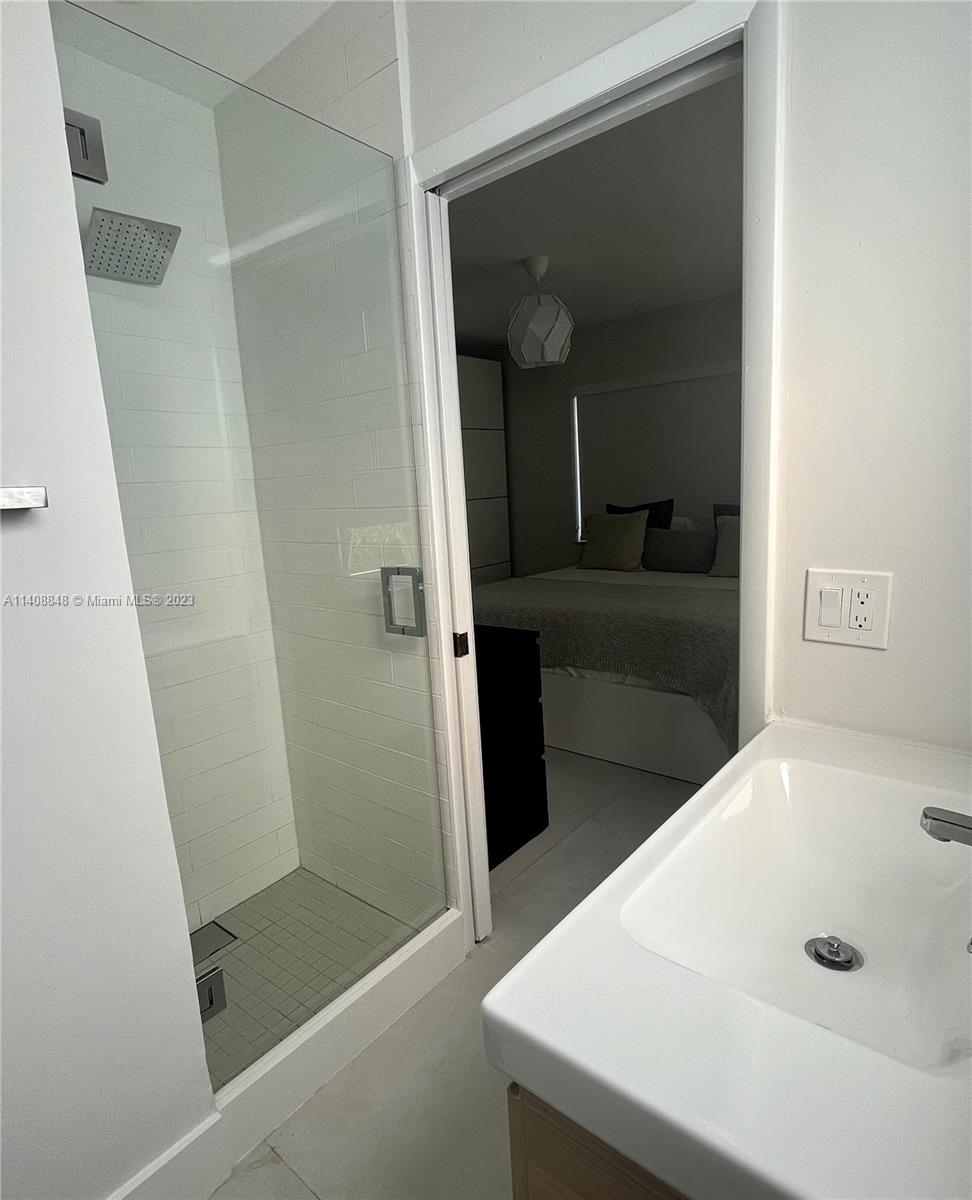 337 Southwest 23rd Road, Unit 1 Miami, FL 33129 - Photo 15 of 31 a bathroom with a tub and shower