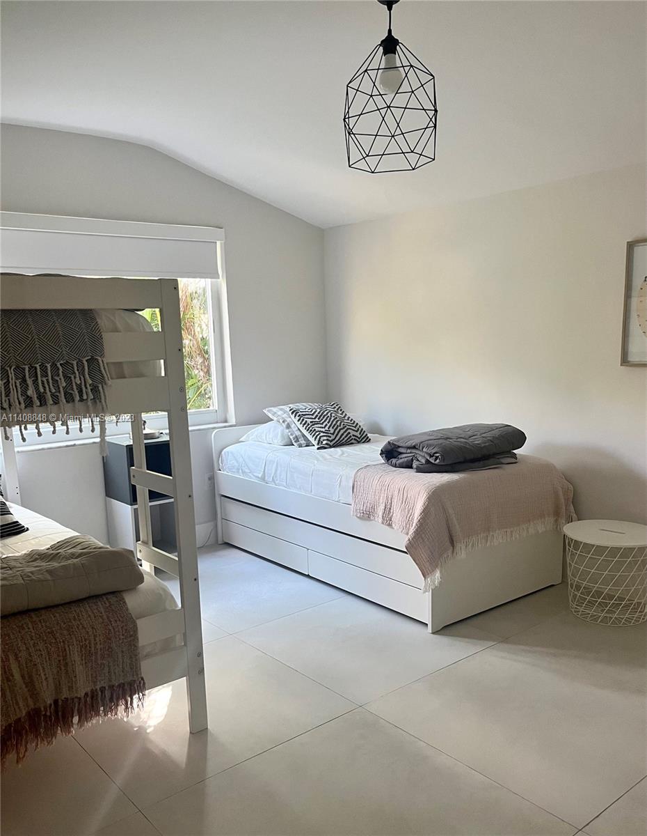 337 Southwest 23rd Road, Unit 1 Miami, FL 33129 - Photo 18 of 31 a bedroom with a bed and window