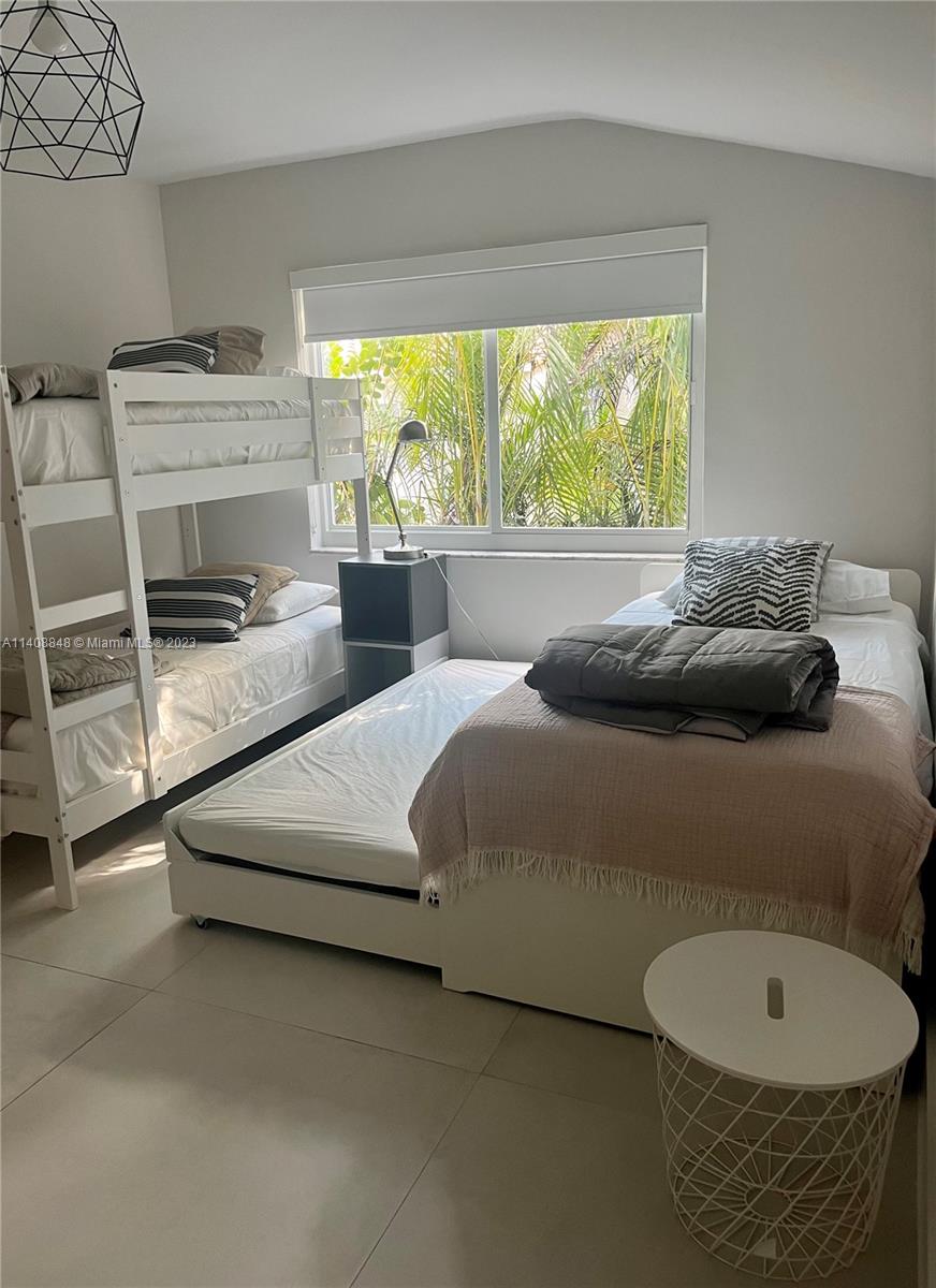 337 Southwest 23rd Road, Unit 1 Miami, FL 33129 - Photo 21 of 31 a bedroom with a bed and a window