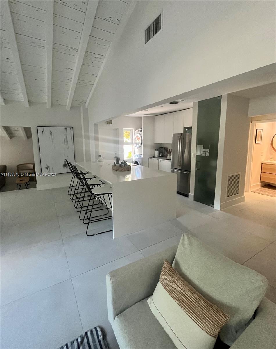 337 Southwest 23rd Road, Unit 1 Miami, FL 33129 - Photo 23 of 31 a living room with furniture and a chandelier