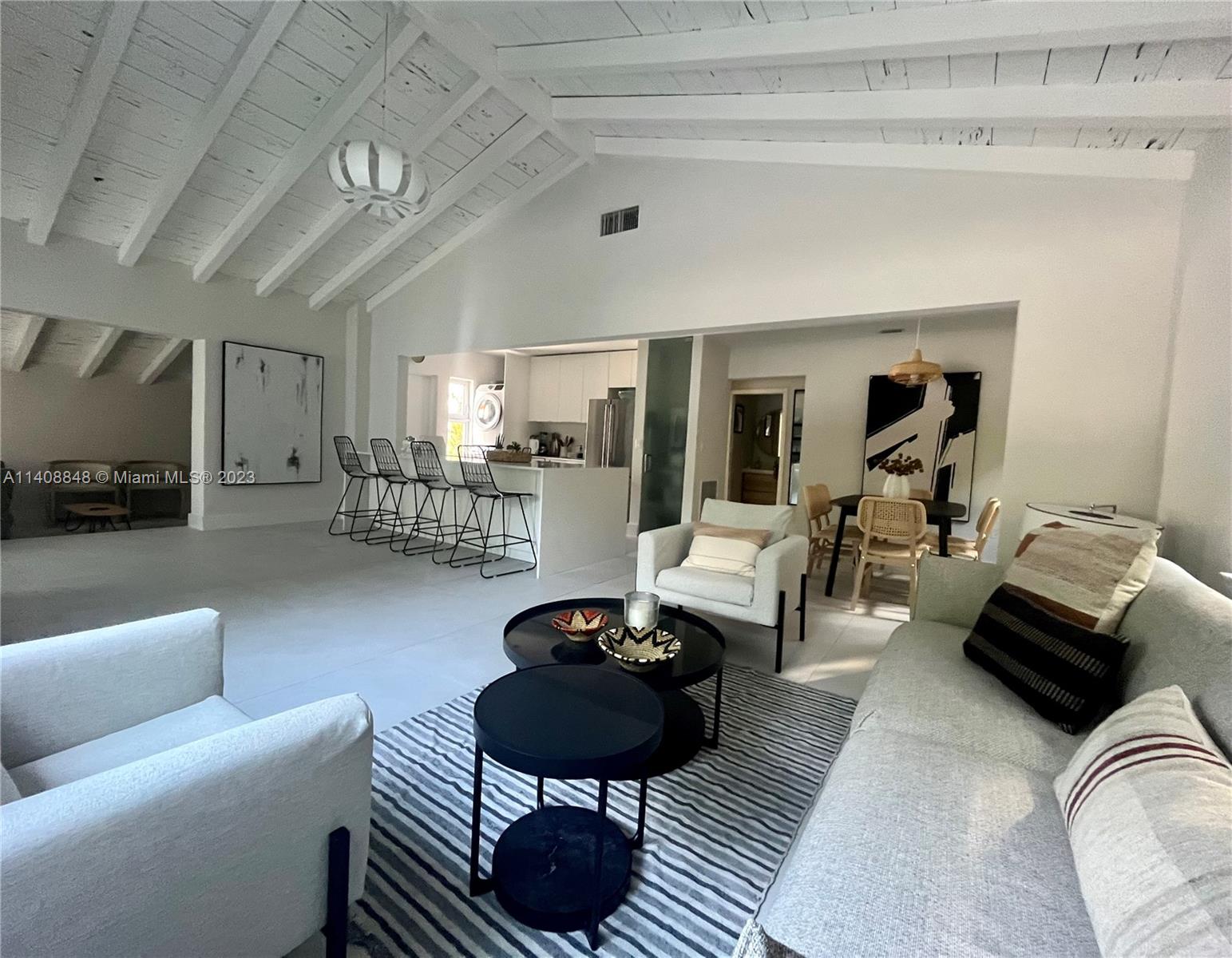 337 Southwest 23rd Road, Unit 1 Miami, FL 33129 - Photo 6 of 31 a living room with furniture a rug and a chandelier