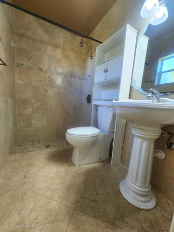 a bathroom with a toilet and a shower
