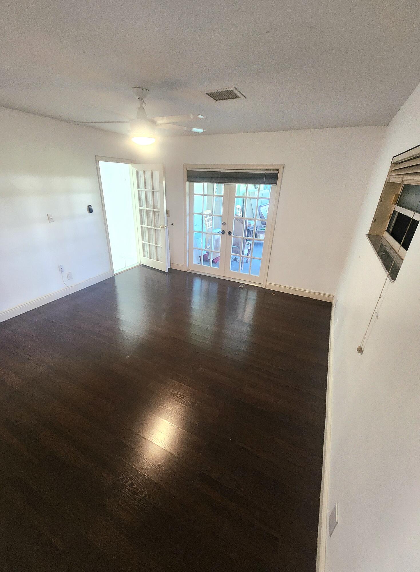 19323 Carolina Circle Boca Raton, FL 33434 - Photo 19 of 24 an empty room with wooden floor and windows