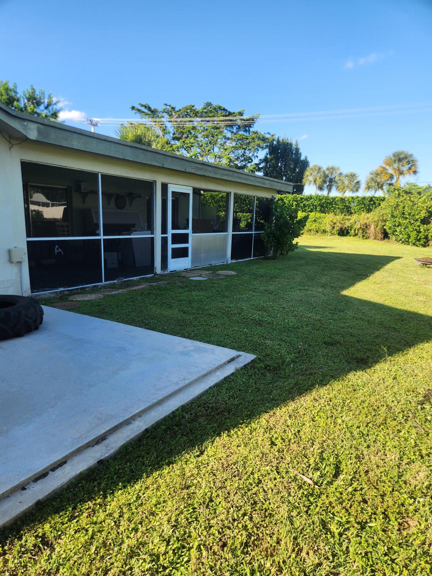 19323 Carolina Circle Boca Raton, FL 33434 - Photo 5 of 24 a view of a house with a big yard and potted plants