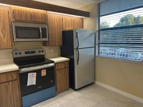 a kitchen with a refrigerator stove and microwave