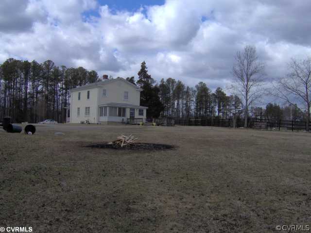 9401 Deer Range Road Moseley, VA 23120 - Photo 2 of 3 a view of a big yard with a house