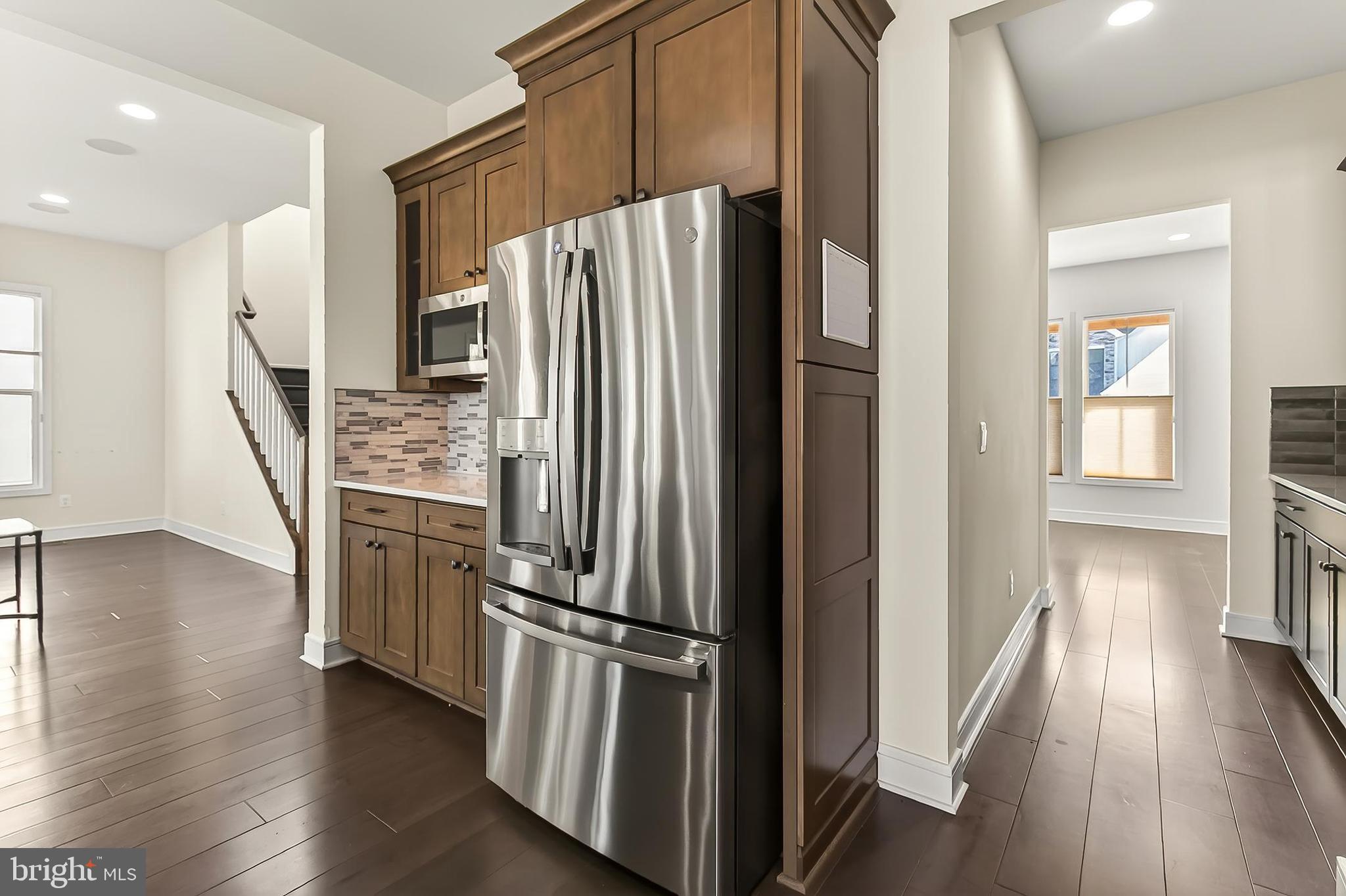 41424 Gentle Wind Place Aldie, VA 20105 - Photo 29 of 83 a kitchen with stainless steel appliances a refrigerator and wooden floor