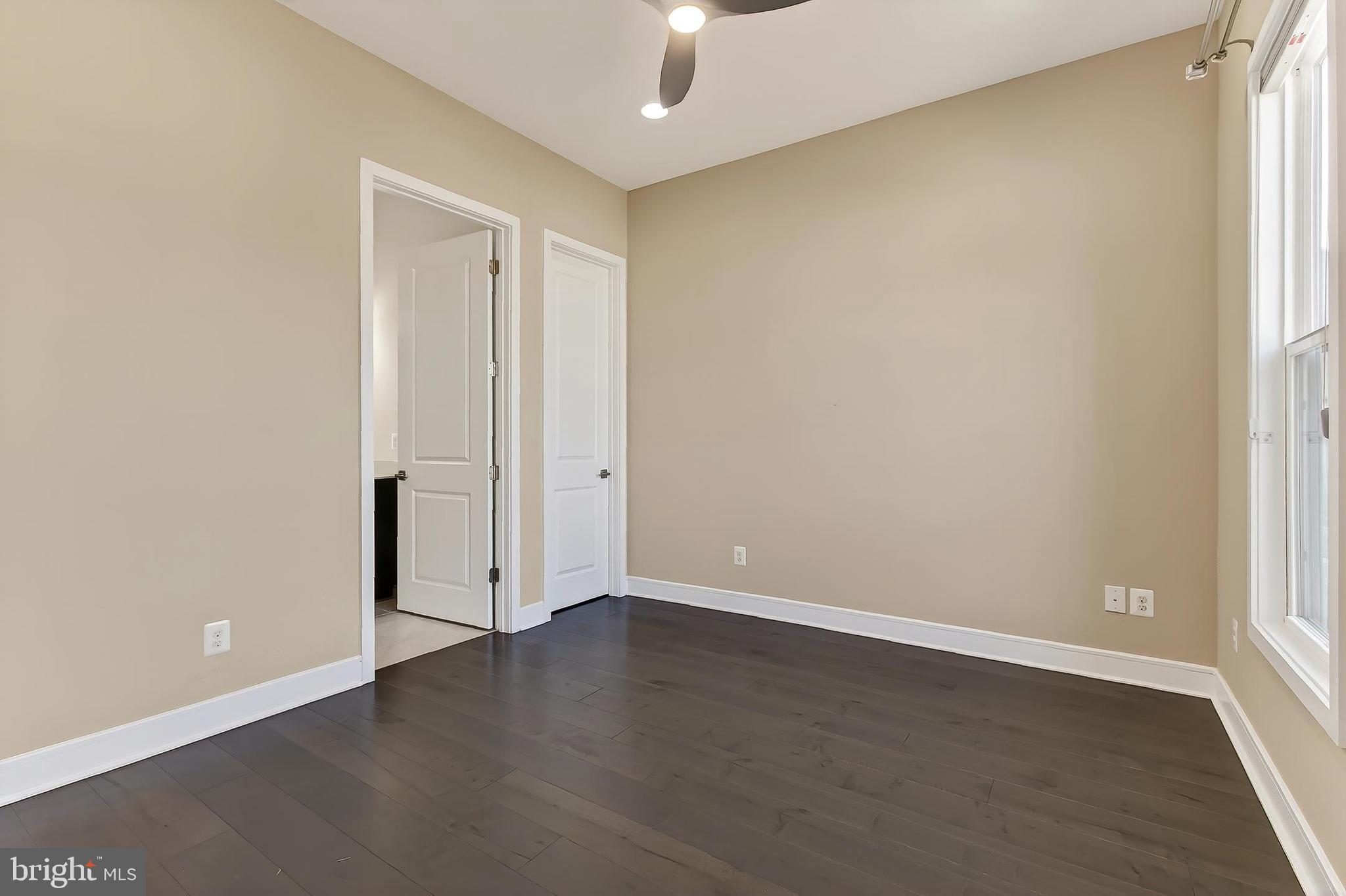 41424 Gentle Wind Place Aldie, VA 20105 - Photo 36 of 83 an empty room with wooden floor cabinet and windows