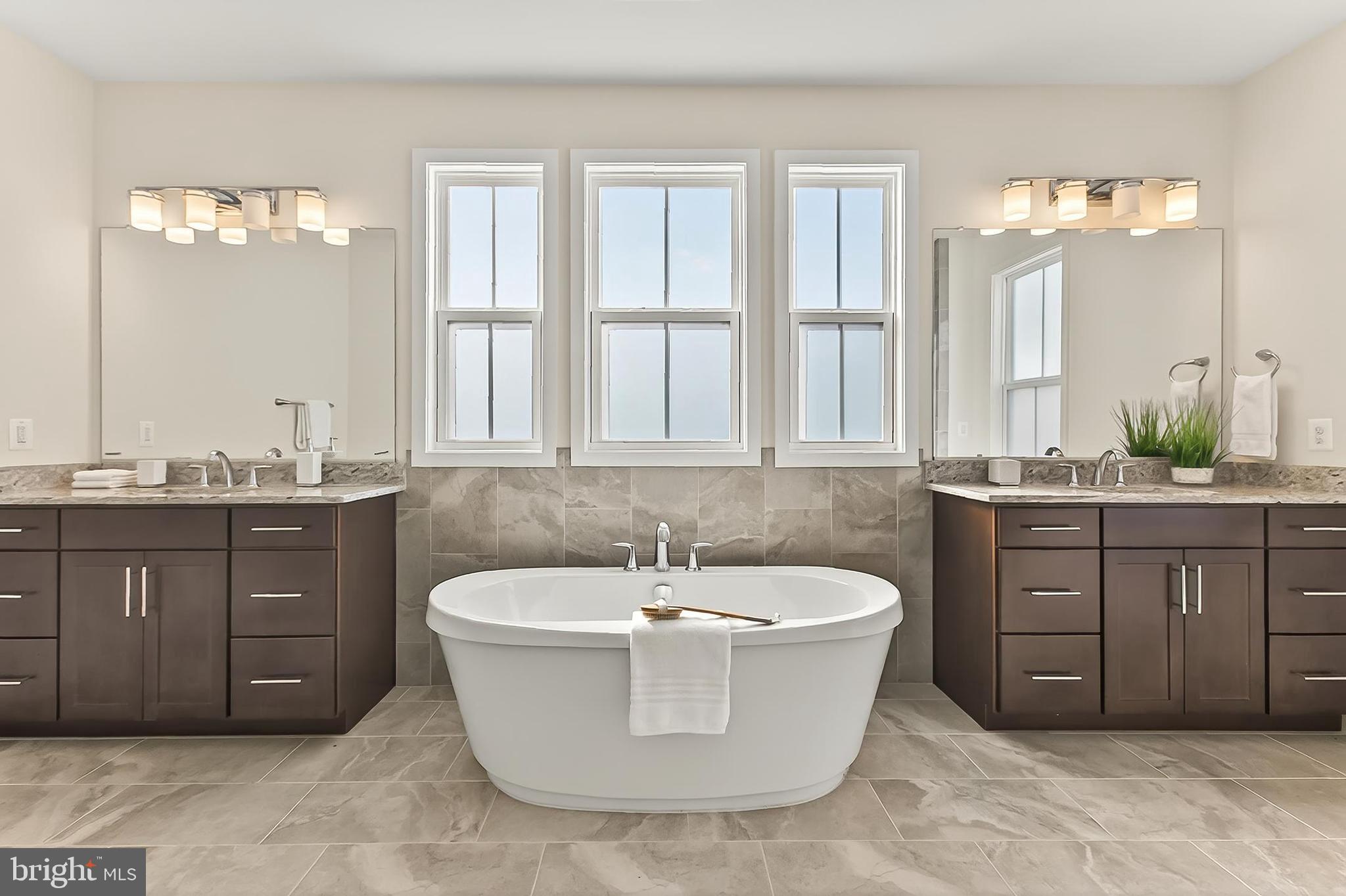 41424 Gentle Wind Place Aldie, VA 20105 - Photo 44 of 83 a spacious bathroom with a tub a double vanity sink a window and a mirror