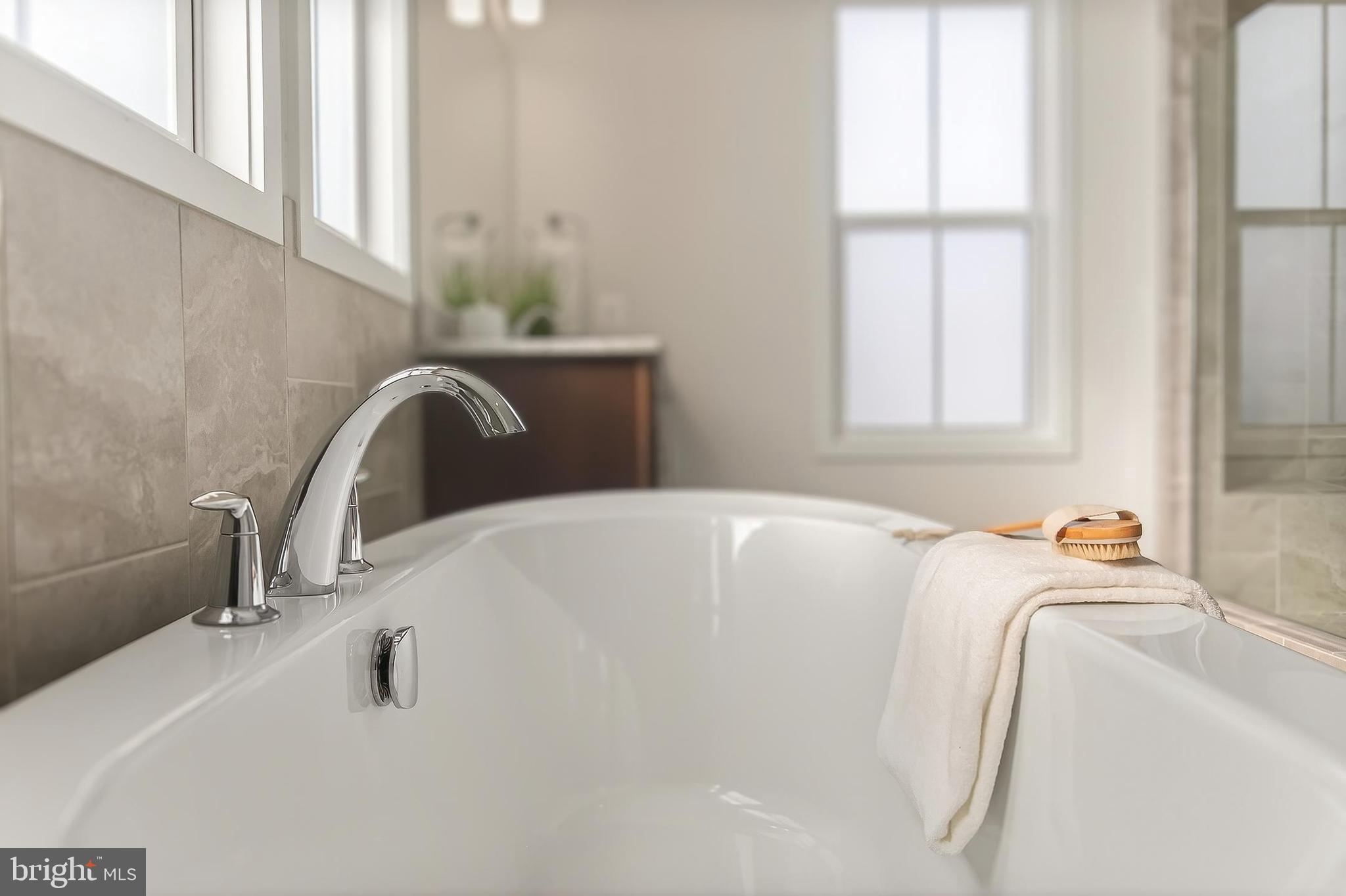 41424 Gentle Wind Place Aldie, VA 20105 - Photo 48 of 83 a bathroom with a tub sink and a window
