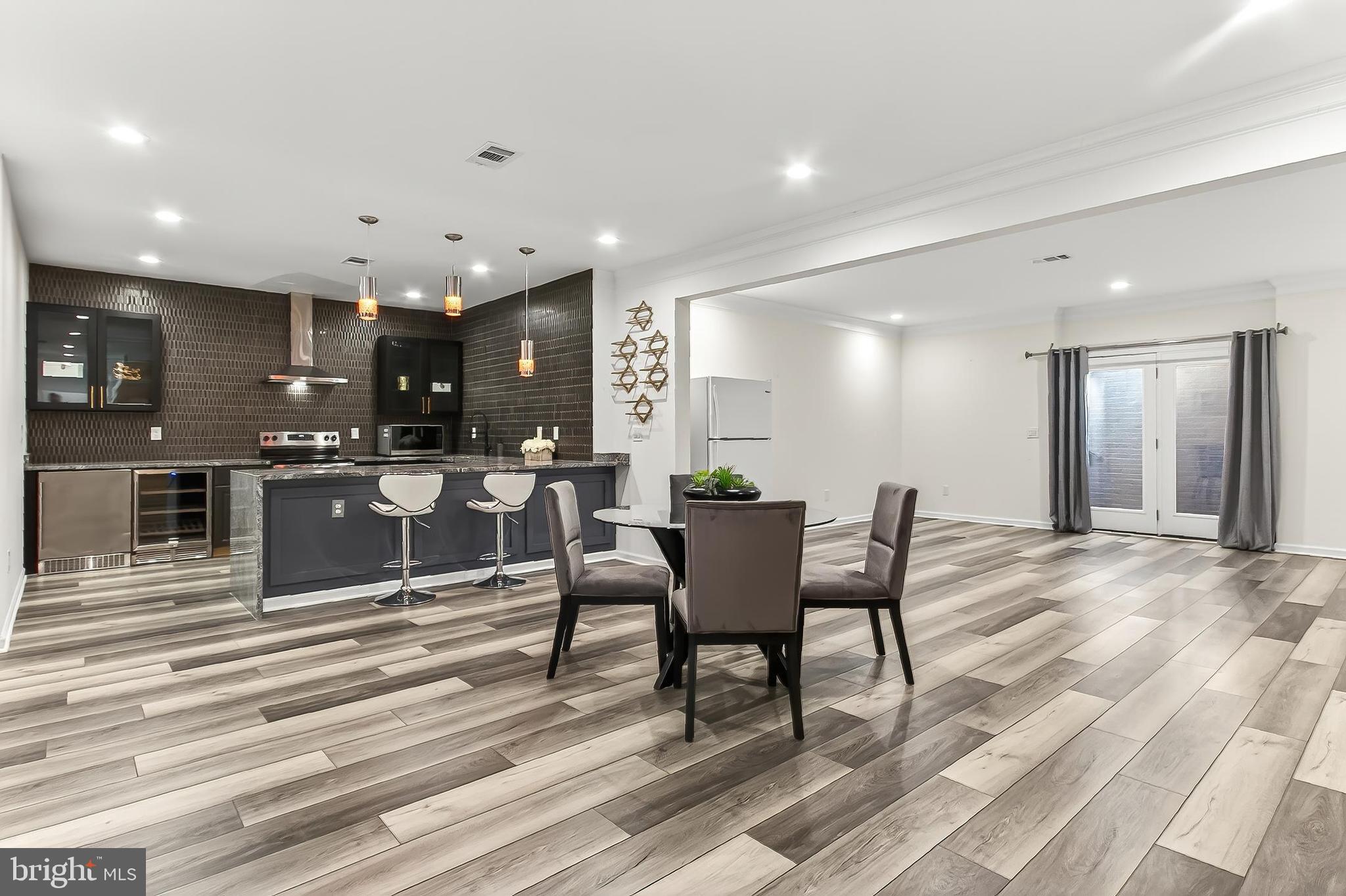 41424 Gentle Wind Place Aldie, VA 20105 - Photo 62 of 83 a open kitchen with stainless steel appliances kitchen island granite countertop a sink and cabinets