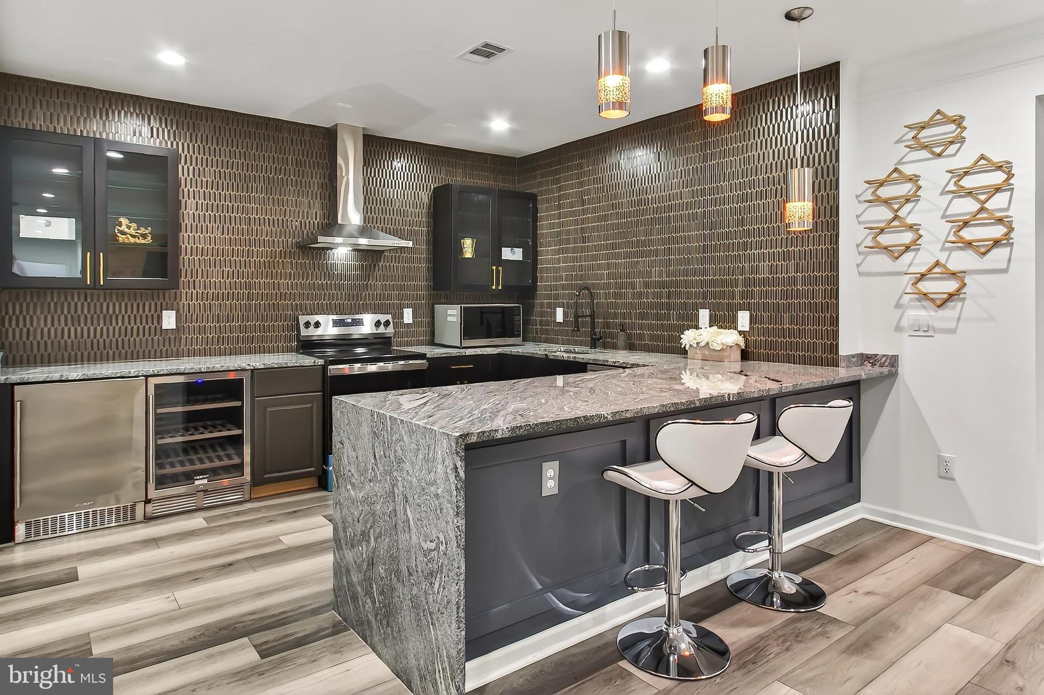 41424 Gentle Wind Place Aldie, VA 20105 - Photo 64 of 83 a kitchen with a sink cabinets and wooden floor