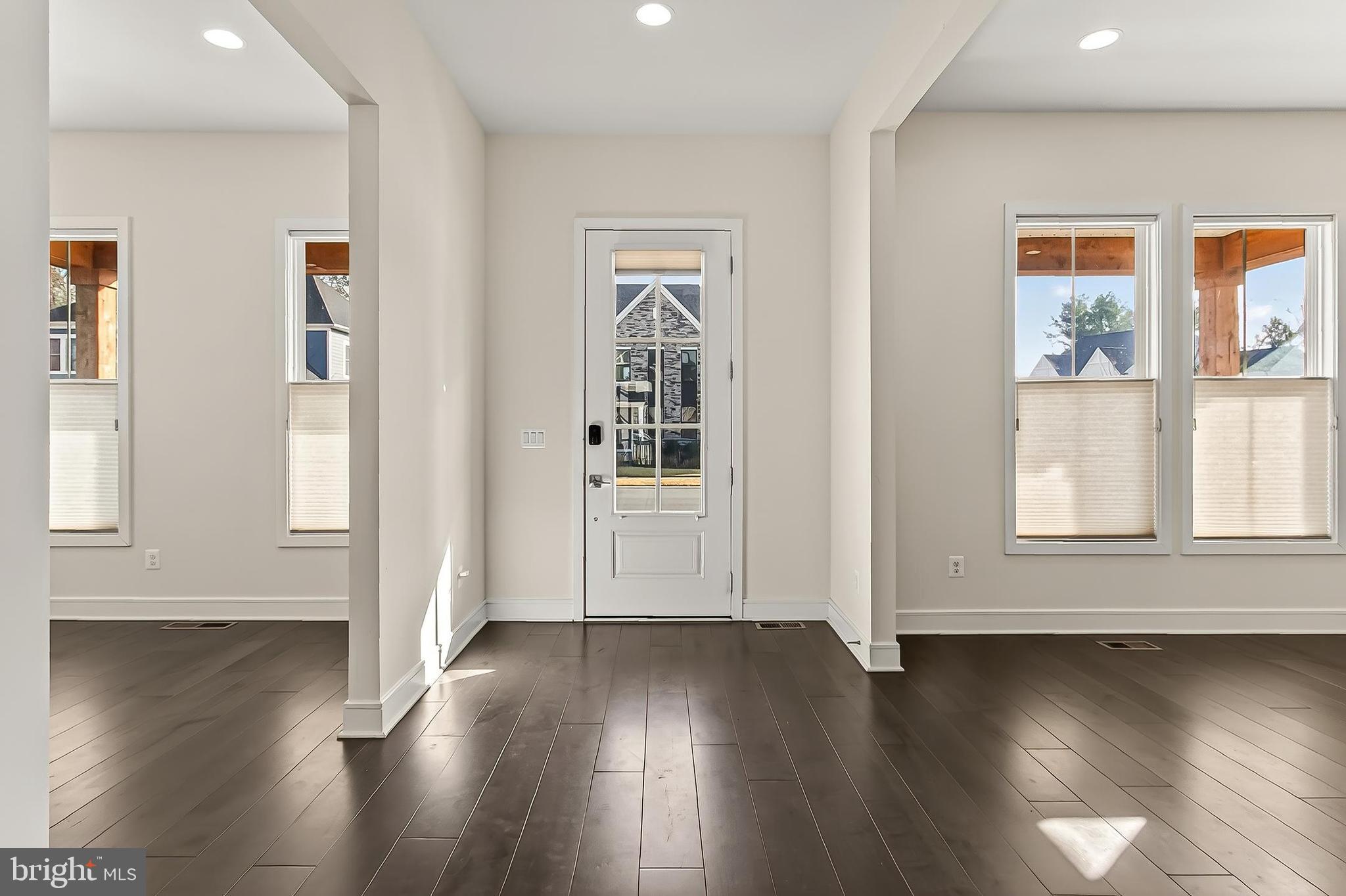 41424 Gentle Wind Place Aldie, VA 20105 - Photo 10 of 83 a view of an empty room with wooden floor and a window