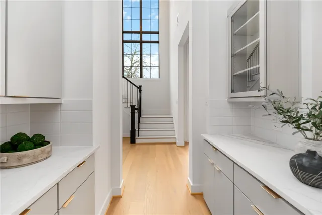 a hallway with a sink and a potted plant