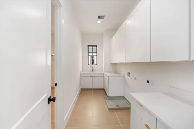 a kitchen with a sink and cabinets