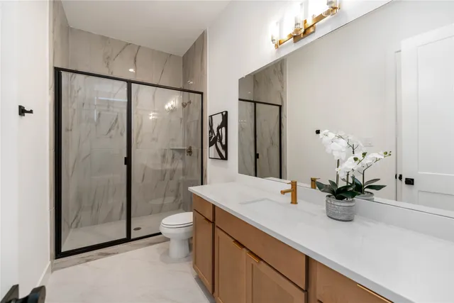 a bathroom with a shower a sink and a mirror