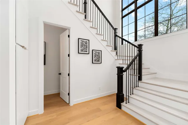 a view of entryway and hall with wooden floor