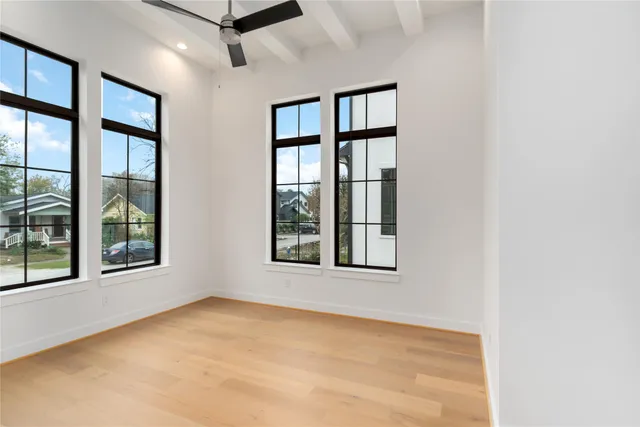 an empty room with windows and closet