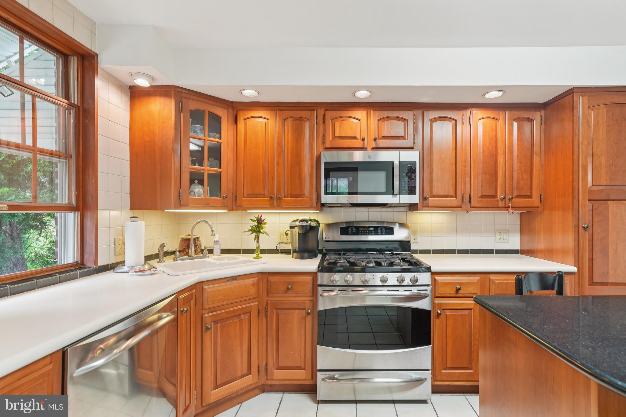 609 Boyer Road Cheltenham, PA 19012 - Photo 14 of 24 a kitchen with stainless steel appliances granite countertop a stove a sink and a microwave
