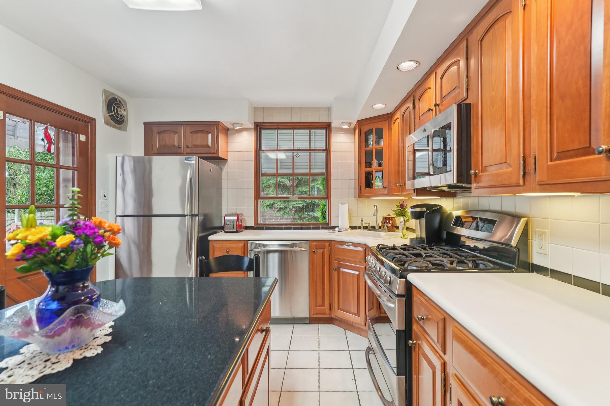 609 Boyer Road Cheltenham, PA 19012 - Photo 15 of 24 a kitchen with stainless steel appliances granite countertop a refrigerator a sink dishwasher a stove and white countertops with wooden floor