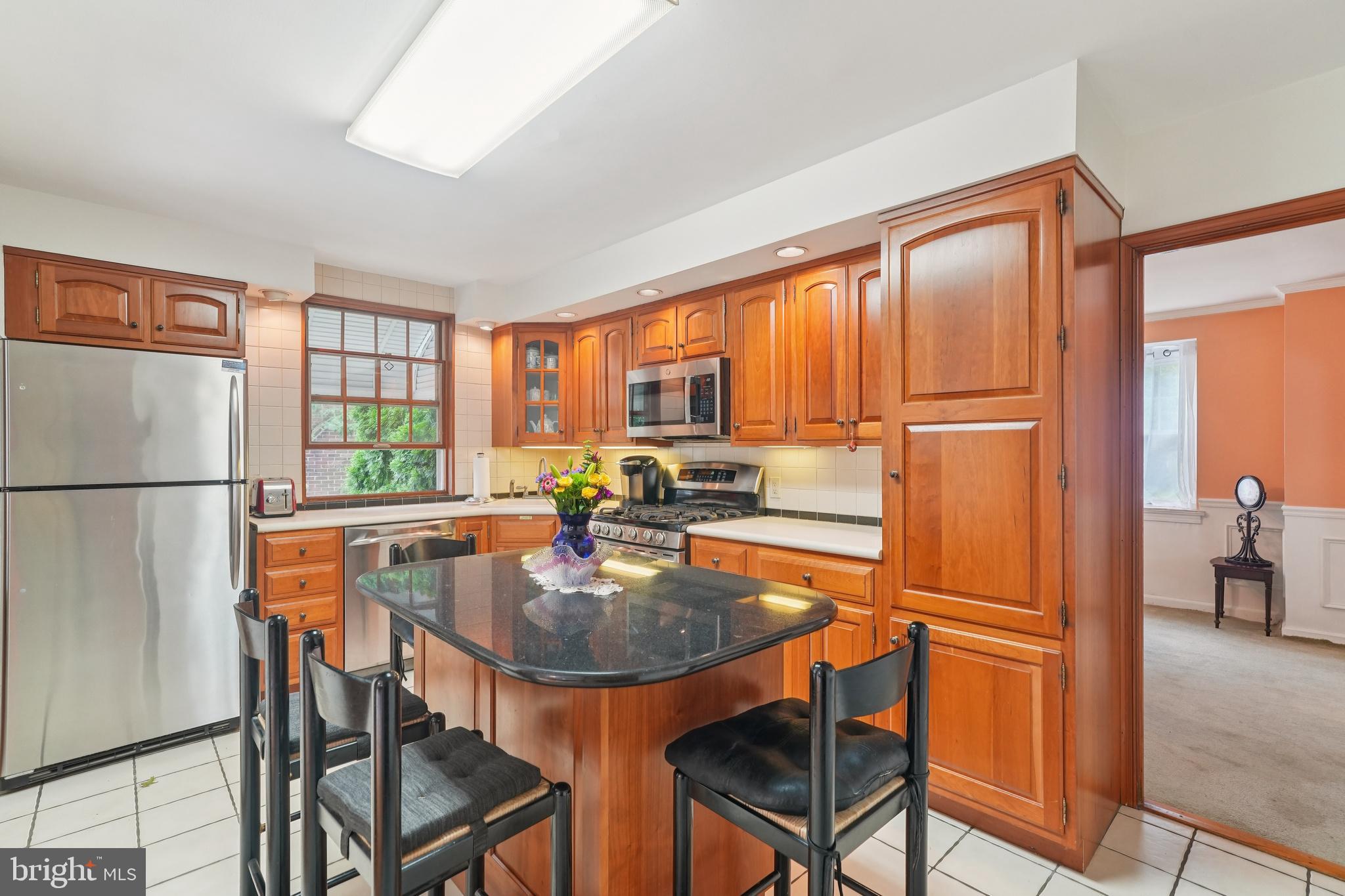 609 Boyer Road Cheltenham, PA 19012 - Photo 5 of 24 a kitchen with stainless steel appliances granite countertop sink refrigerator dining table and chairs