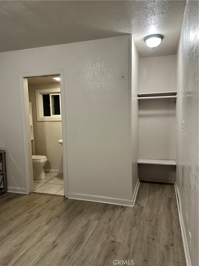 7459 Ysmael Villegas Street Riverside, CA 92504 - Photo 4 of 8 a view of a room with wooden floor and bathroom