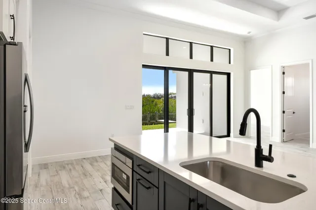 a large room with wooden floor and windows