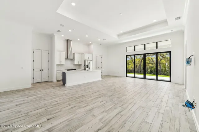 a big room with wooden floor and windows