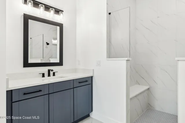 a bathroom with a double vanity sink mirror and