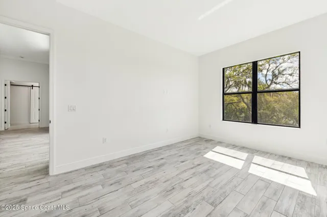 a kitchen with a sink cabinets and wooden floor