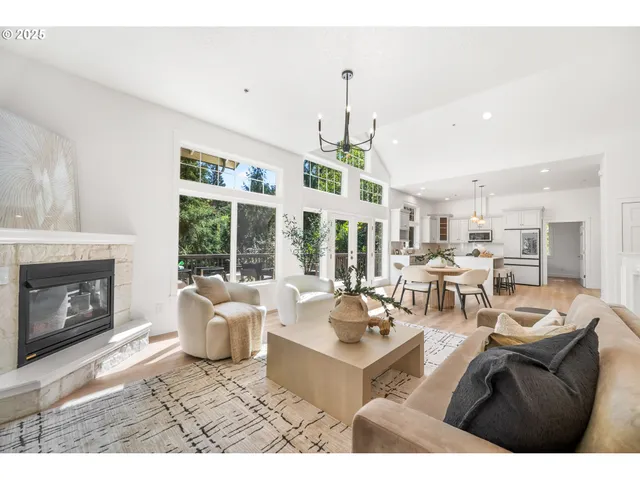 a living room with furniture a fireplace and a chandelier