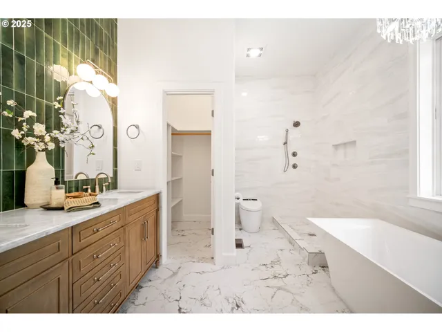 a bathroom with a granite countertop sink a toilet and shower