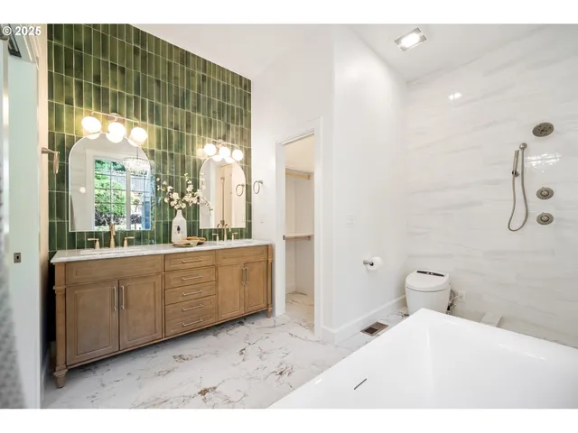 a bathroom with a tub sink and mirror