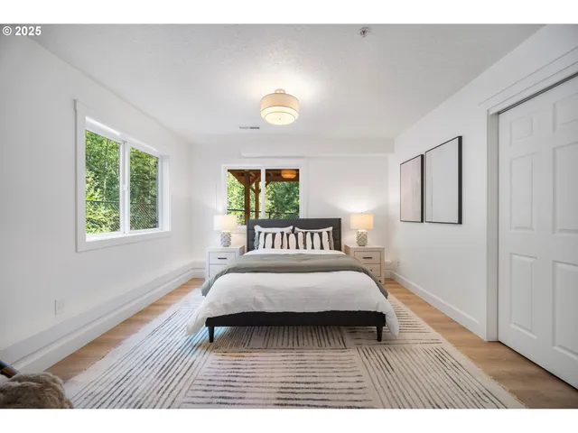 a bedroom with a bed and a wooden floor