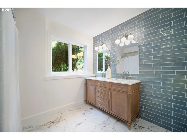 a bathroom with a sink mirror and a bathtub