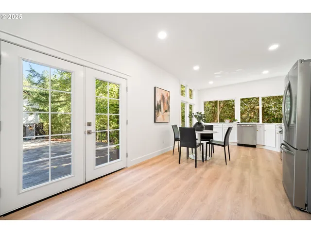 a dining room with furniture and wooden floor