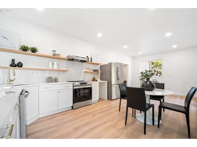 a open kitchen with stainless steel appliances kitchen island granite countertop a sink and cabinets