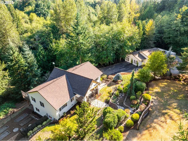 an aerial view of a house with a yard