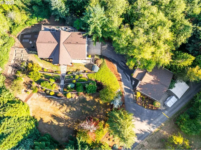 an aerial view of a house with a yard and swimming pool