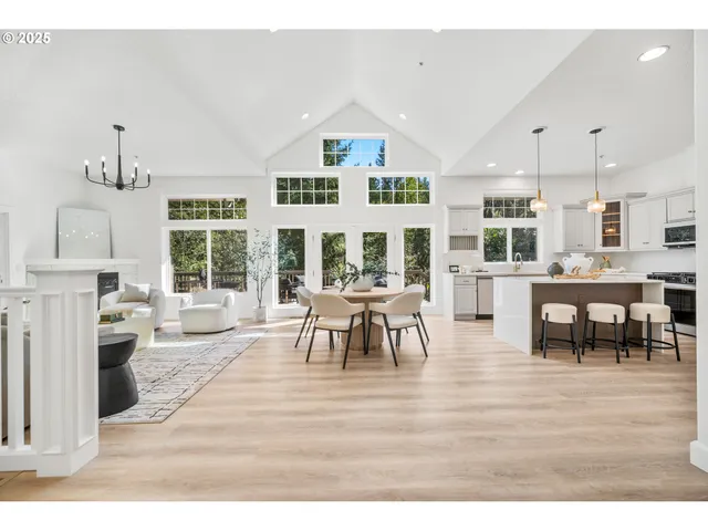 a living room with furniture and a dining table with kitchen view