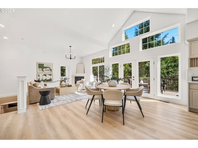 a living room with furniture a wooden floor and a large window