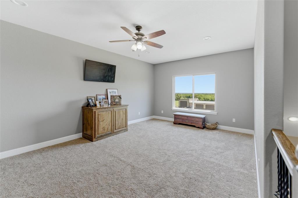10106 Prather Road Springtown, TX 76082 - Photo 25 of 40 a living room with furniture and a flat screen tv