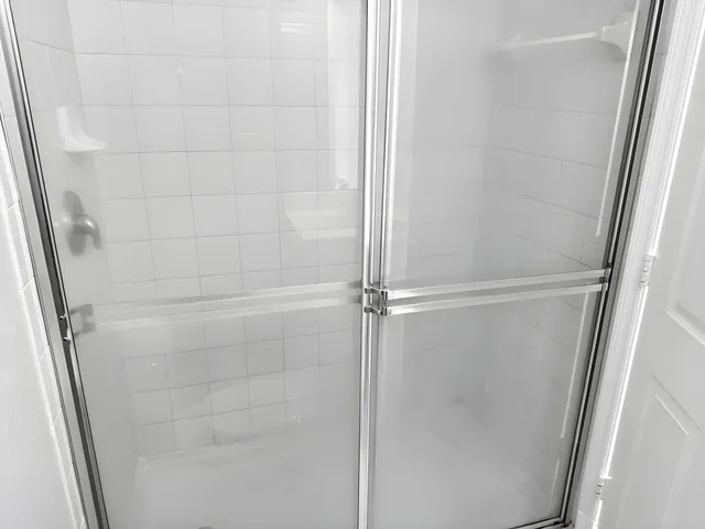 a bathroom with a glass door shower