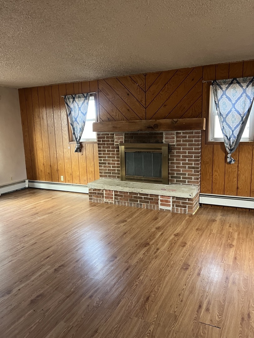 4304 West Lily Creek Road Freeport, IL 61032 - Photo 24 of 53 an empty room with wooden floor and windows