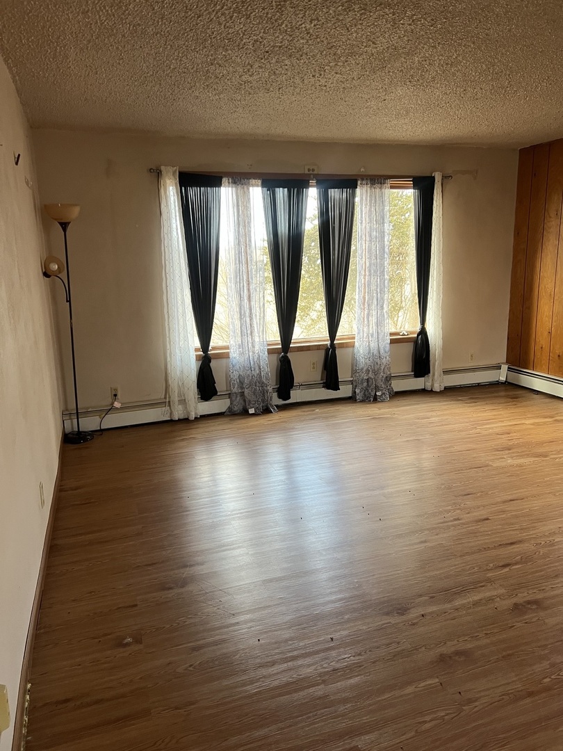 4304 West Lily Creek Road Freeport, IL 61032 - Photo 25 of 53 a view of room with floor to ceiling window and wooden floor