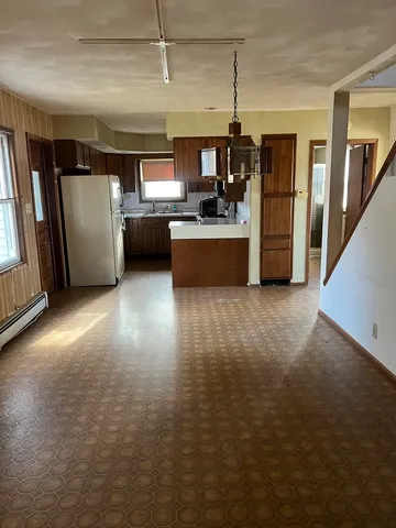 a kitchen with granite countertop a stove top oven and cabinets