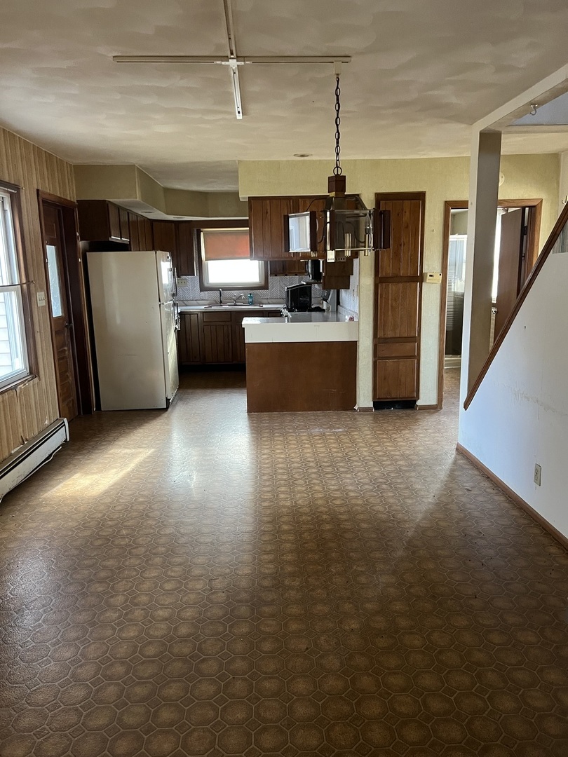 4304 West Lily Creek Road Freeport, IL 61032 - Photo 27 of 53 a kitchen with stainless steel appliances granite countertop a refrigerator and a sink