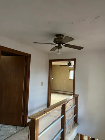 a view of a livingroom with wooden floor and a window