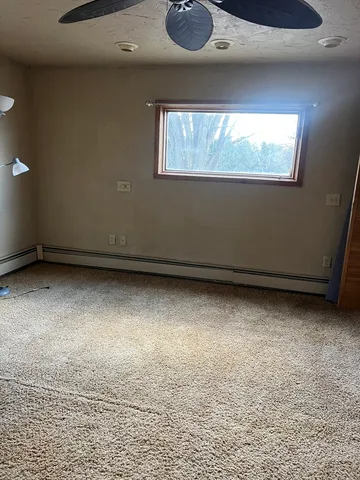 a room with water heater and car parked