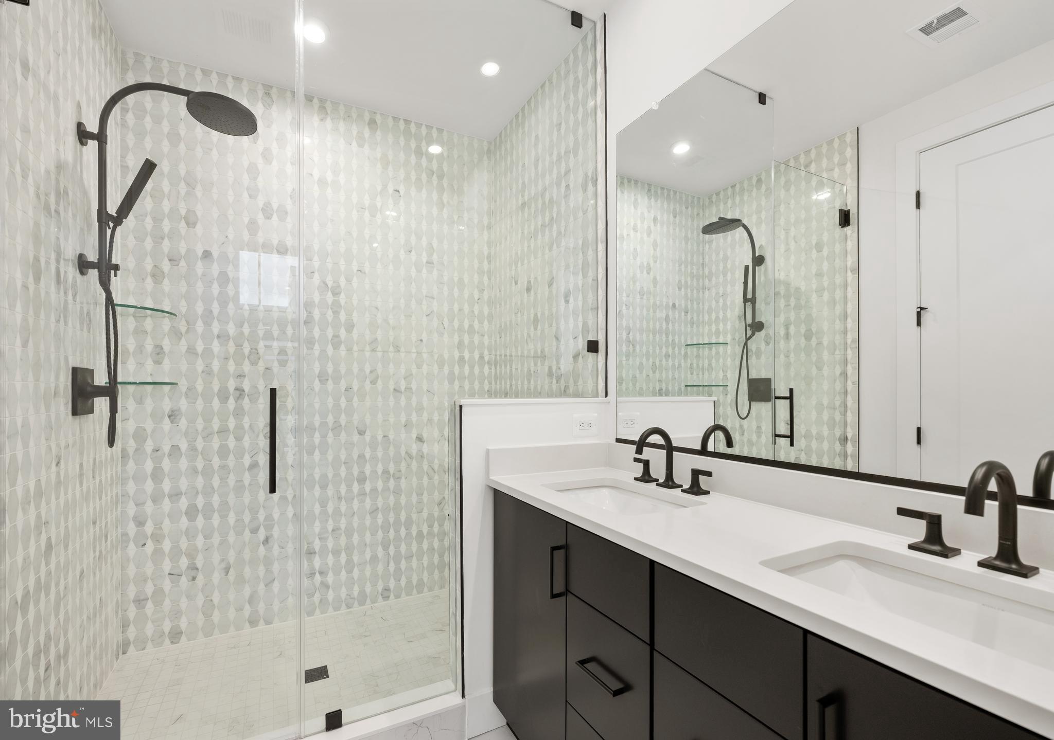 8616 Erdem Place Chevy Chase, MD 20815 - Photo 6 of 12 a bathroom with a double sink shower and a mirror